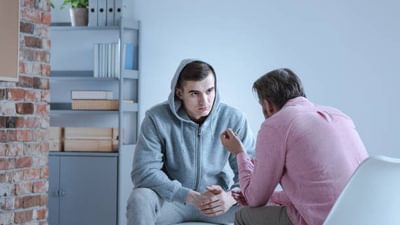 A psychology specialist explaining an action plan for recovery to a troubled teenage boy