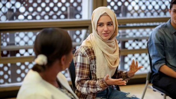 Muslim college students talking to a group in counseling